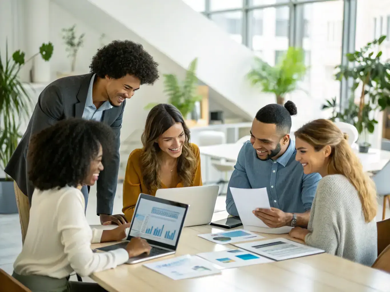 A sales team in a bright office reviewing a digital sales pipeline dashboard, with charts and deal stages visible, symbolizing optimized sales processes for solar energy companies.